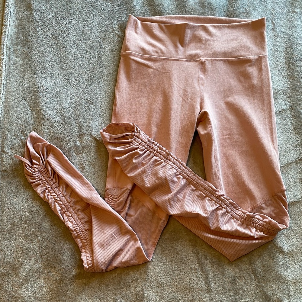 Fabletics leggings in the color pink with adjustable sinched bottoms